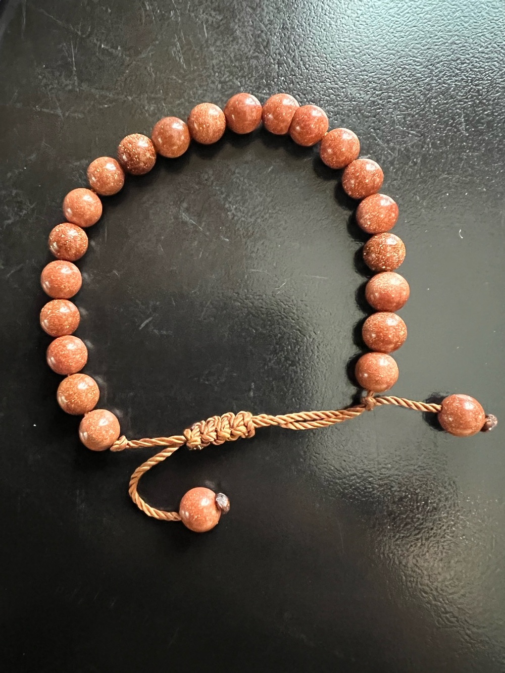 Goldstone beaded bracelet metallic glitter flakes suspended reddish brown stones